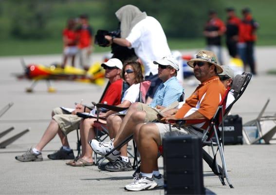 The judging panel midday. They sit on the boiling Tarmac while videographers capture all the action in 2010 XFC event.