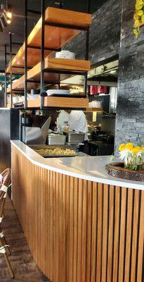 Semi open kitchen by the main dining room area. Can see a whole tray of their delicious fried cauliflower they use in various dishes.