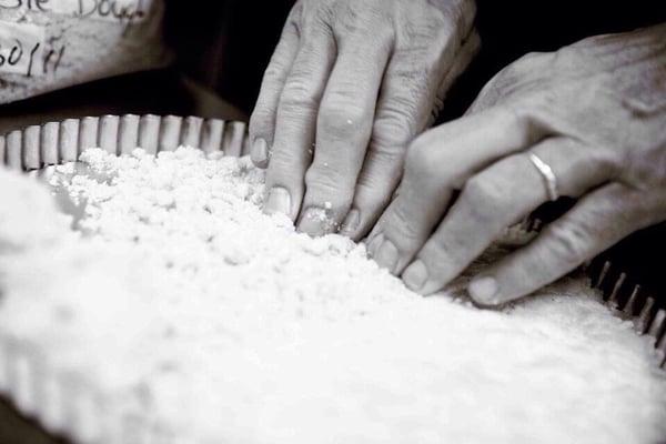 The hands of a chef. Chef making sablé tart shells.