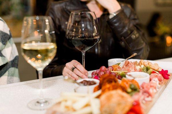 Guests enjoy wine and charcuterie