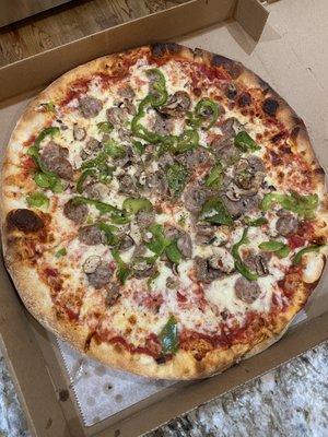 Large custom pizza with sausage, peppers, and mushroom