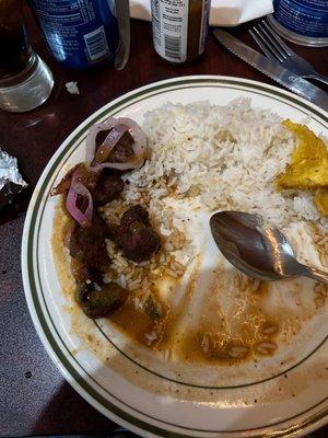 Fried pork with rice and beans.