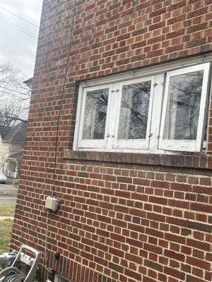 A customer's window broken with materials thrown out of an upper window