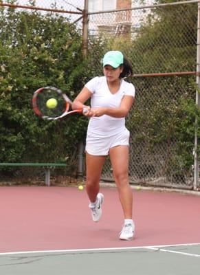 Tipper Truong hitting a two-handed backhand