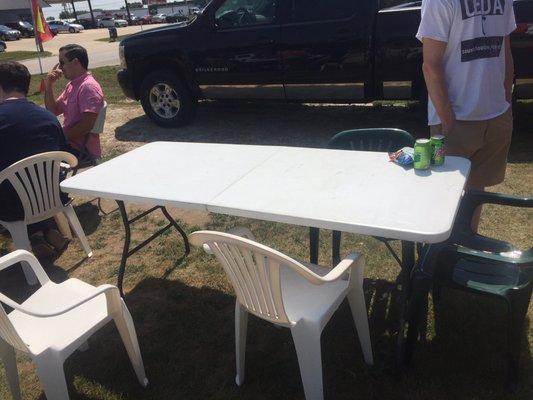 A few cafe and folding tables with patio chairs make up their seating area.