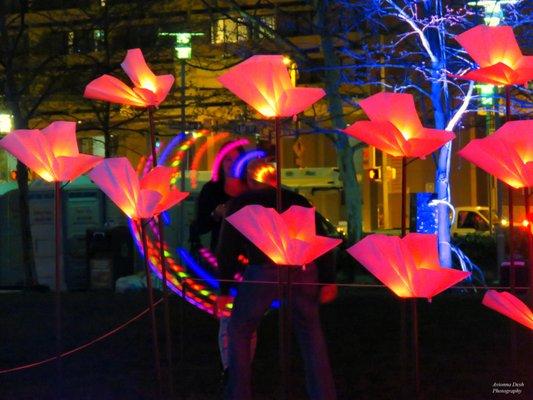 On the Wings of Freedom. Artist: Aether & Hemera (United Kingdom).  In the background is a couple with a lighted hula hoop.