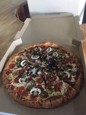 Pizza with mushrooms jalapeños black olives onions and pepperoni.