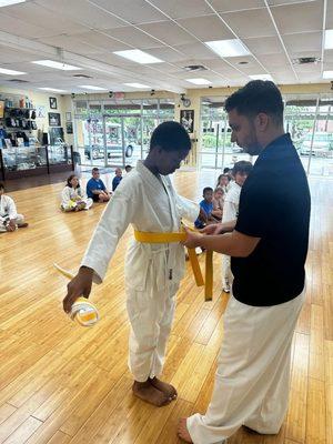 My oldest getting his yellow belt