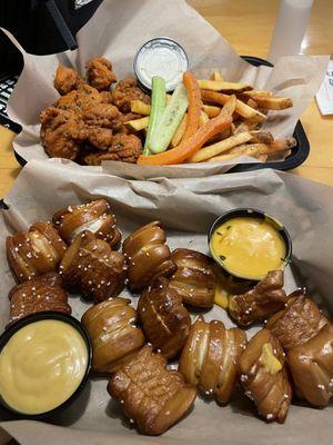 My food. Pretzel with cheese. Wings with French fries.