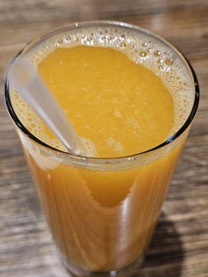 Close-up of the glass of freshly squeezed orange juice.