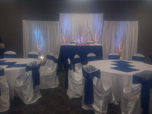 Classic indoor wedding reception at the Convention Center. Soft up lights and classic white and royal blue. Beautiful.