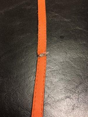 Broken purse strap. Mike (owner) custom made new matching orange leather straps.