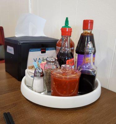 Lazy Susan with all kinds of sauces for your pho