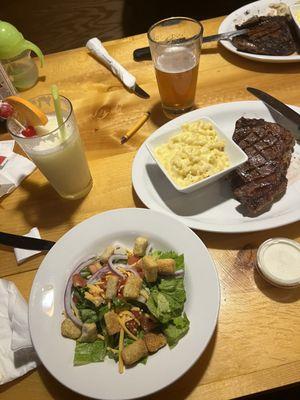 Side salad, Mac & cheese, 8oz New York strip steak Pina colada & boneyard beer