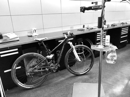 A black and white picture of my bike during pick up. The shop is clean and organized.