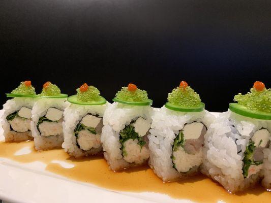 Our delicious Foothill roll contains imitation crab cream cheese yellowtail and cilantro, on top is green tobiko and jalapeño slices