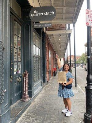 Outside signage with Jackson Square in the background. The brown paper bag is hiding the fun packing job they do!