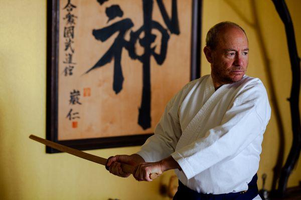 Instructor Ed Reiff practicing techniques with a bokken (wooden sword).