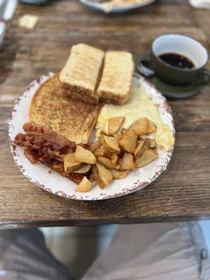 2 eggs scrambled with cheese , French toast , home fries, one meat (bacon) ,and white toast.