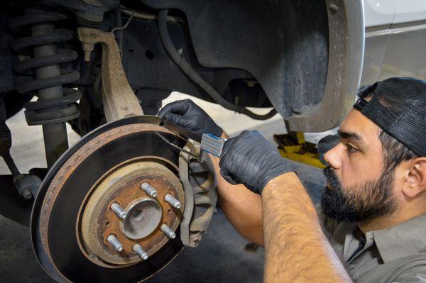 Eurasian Auto Repair ASE certified technician working on brake repair in San Antonio