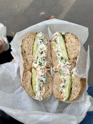 Whole wheat everything bagel with tofu veggie cream cheese and cucumbers