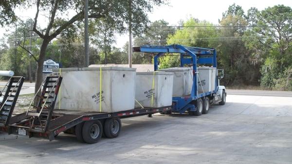 Rail Truck Hauling off a Load of Septic Tanks. 