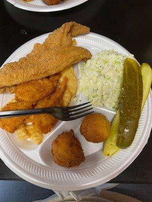 Catfish fillets, fried shrimp, coleslaw, fries, pickles and hush puppies