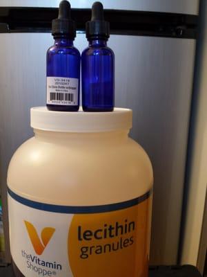 Lecithin and royal blue oil bottles with dropper