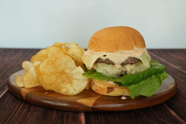 1/2 Pound Ribeye Burger, Thousand Island, Grilled Onions, Arugula, Tomato, White Cheddar Cheese on a Fresh Baked Bun.