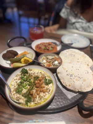 Platter with Charred Chickpea Hummus, Falafel, pita bread, Side Muhammara, Eggplant and Pickles