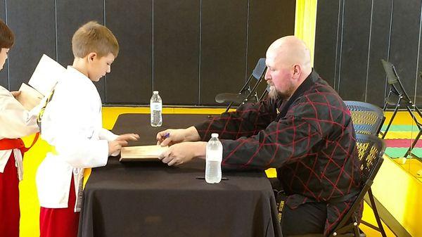 Master Ron signs first board broken.