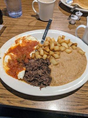 Ranchero Eggs Overeasy with barbacoa, potatoes and beans