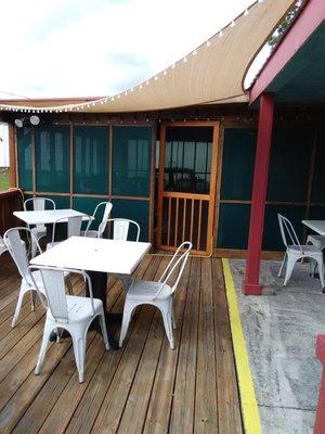 Outdoor patio with enclosed patio in the background