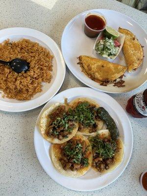 Birria tacos, side arroz, and adobada tacos