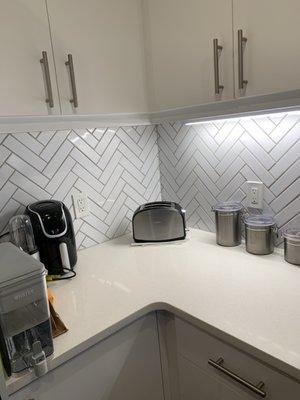 Custom backsplash, chevron style.. painted cabinets.