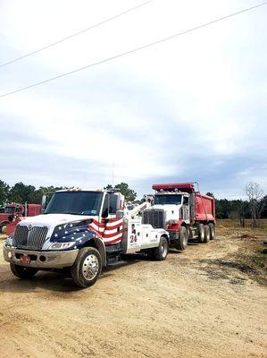 W-24 towing triple axel dump truck