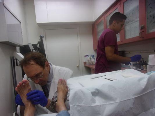 Having my foot ulcer debrided, medicated, dressed by Dr. Franklin Kase..assisted by Michael.