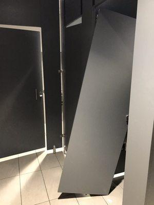 Door to the bathroom stall in the women's room literally ripped off of the hinges.