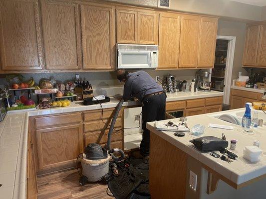 Desi working on modifications to the tile countertops.