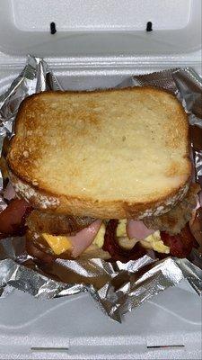 Honey Ham, sausage, bacon, eggs & cheese Sandwhich