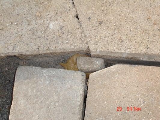 Misplaced stone in glob of caulk, part of "repair"