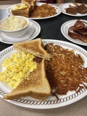 Two Scrambled Eggs with Buttered Toast, Hashbrowns, Cheese Grits and Bacon