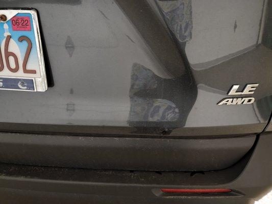 Trunk of our car with raised bump and discoloration