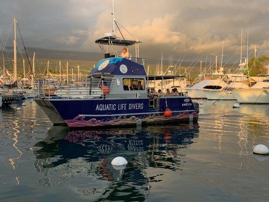 One of our two identical boats departing during the Golden Hour of sunset for the manta dive and snorkel