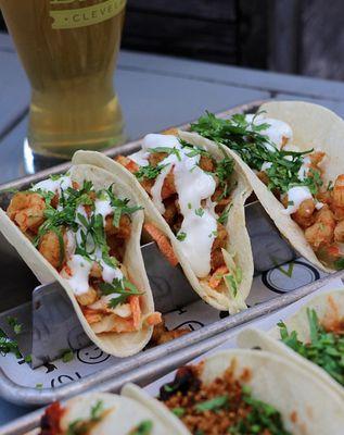 Shrimp Tacos -- cumin chili wild shrimp, cabbage claw, lime and chili crema, cilantro