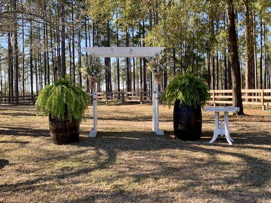 White door pergola with Whiskey Barrels