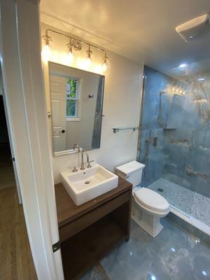 Wood vanity with blue tiles