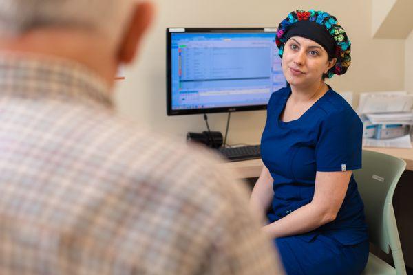 Kim our medical assistant talking with our patient