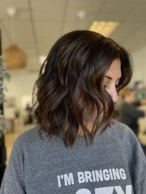 Lob haircut on brunette with dimensional blonde highlights