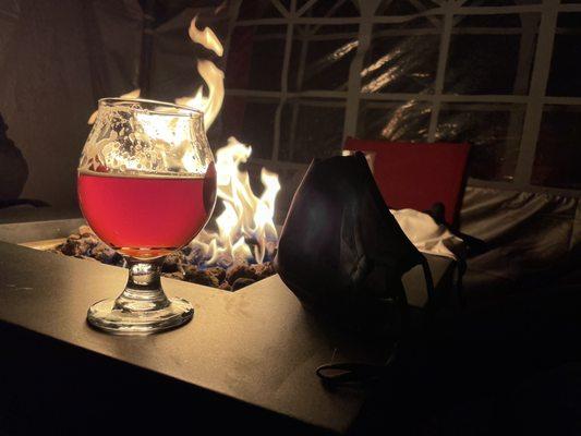 Outdoor tent with fire and a brew.